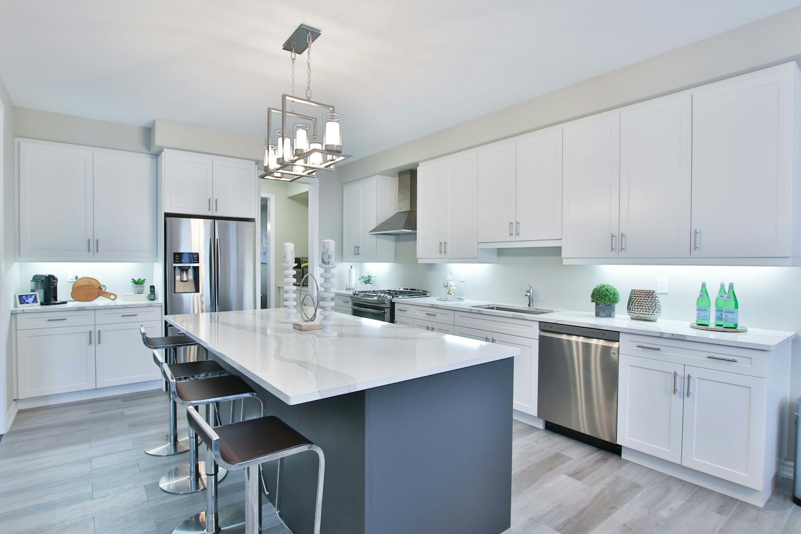 Renovated kitchen with white cabinets and an island