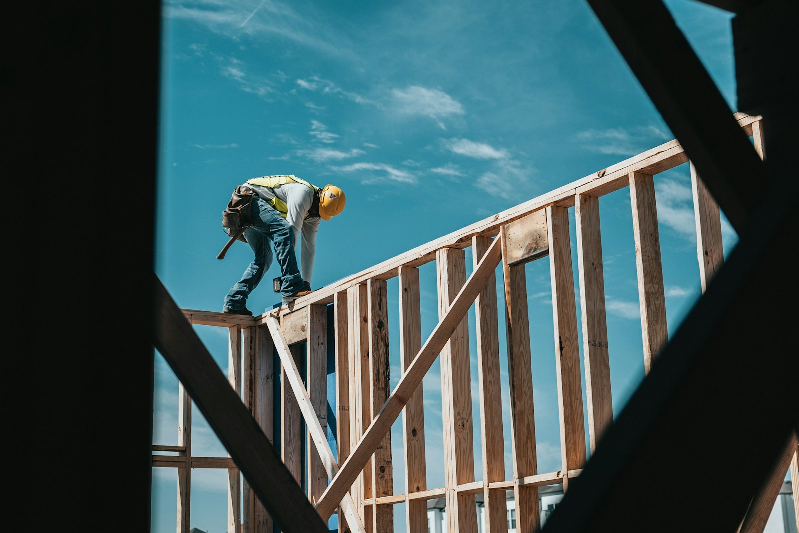 Carpenter framing the wall of a new house