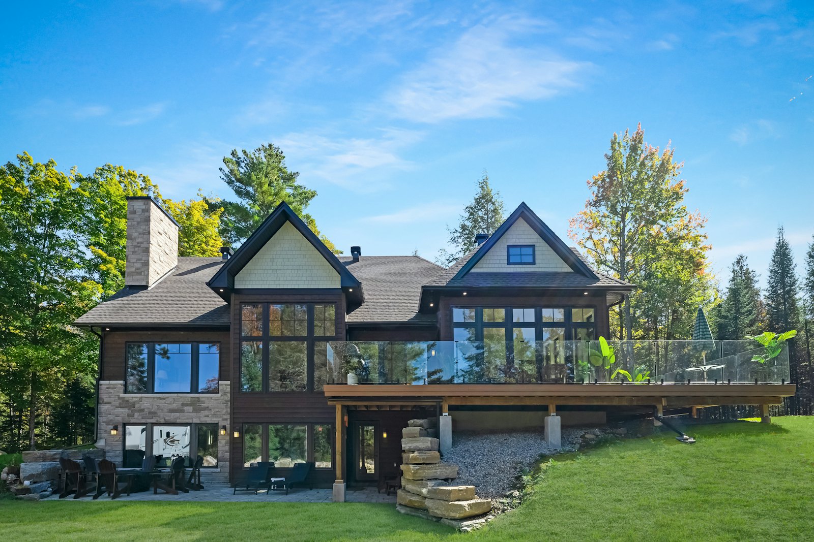 Large house with a wooden deck and lawn