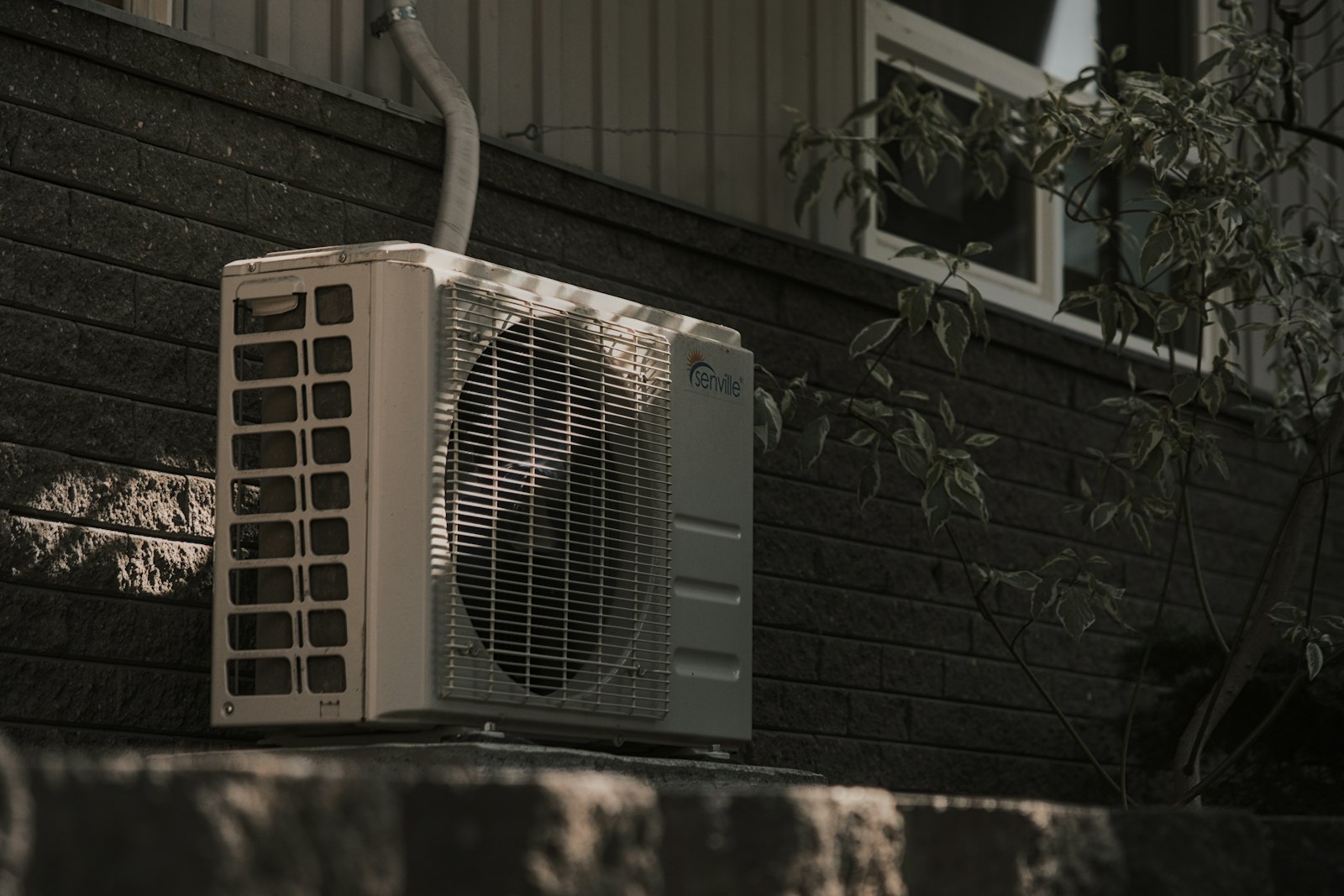 Outdoor air conditioning unit beside a house